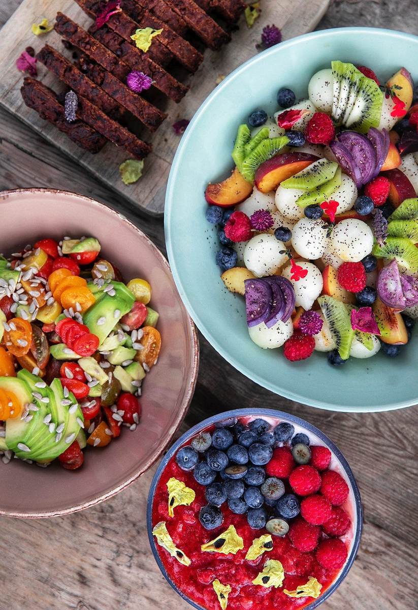Bowls of fruit, tomatoes and avocado