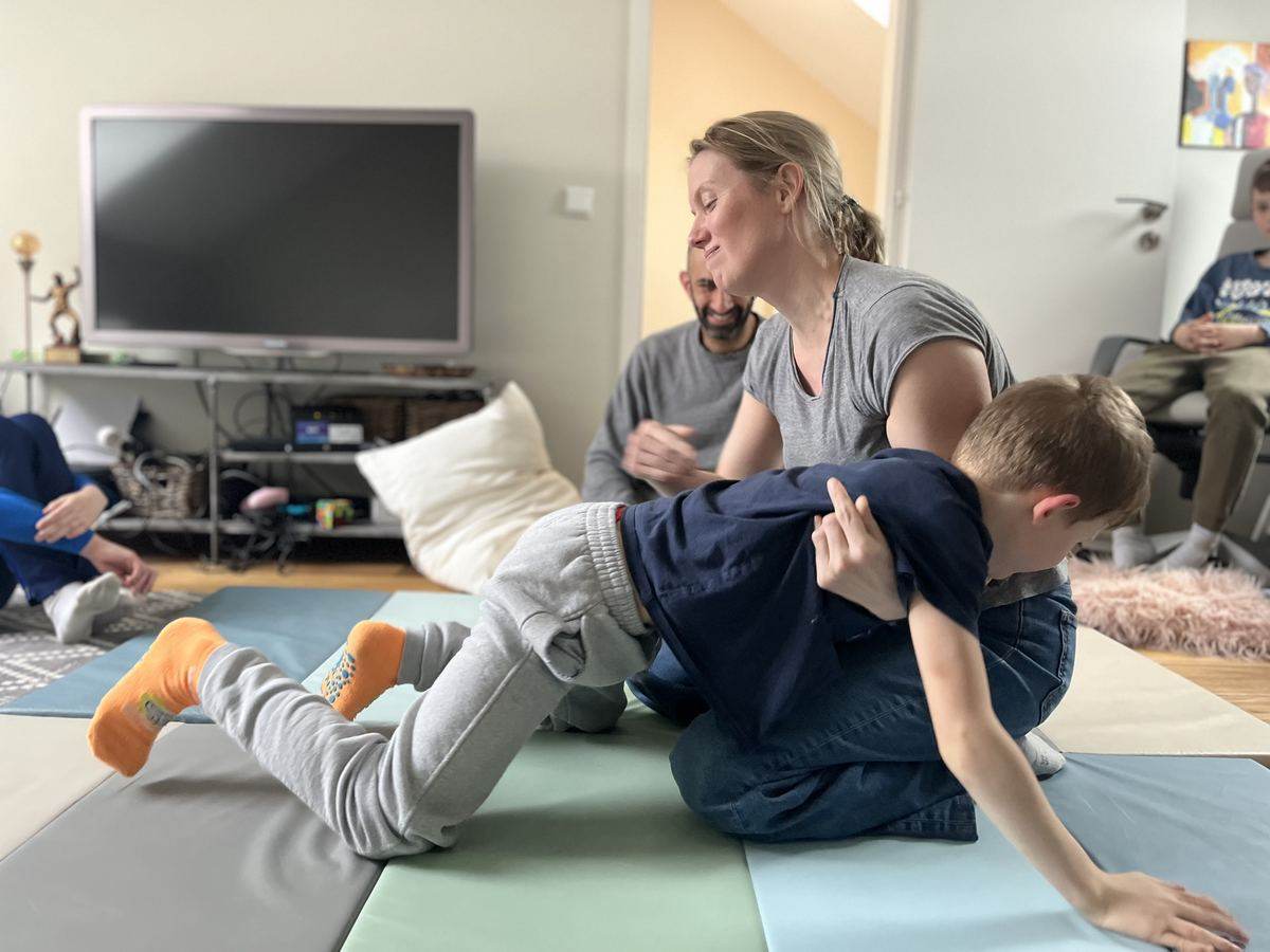 A parent and child on the mat during playfight