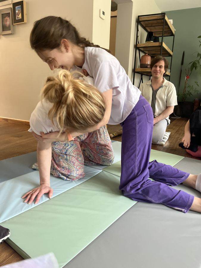 Two children playfighting on a mat