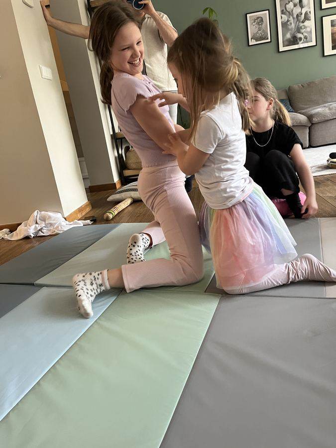 Children on the mat during a playfight workshop